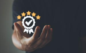 The hand of businessmen shows the sign of the top service Quality assurance, Guarantee, Standards, ISO certification and standardization concept, customer satisfaction, and service experience. - image iStock-1406135787-300x184 on http://gcs-international.com